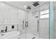 Elegant bathroom featuring a modern shower with dual shower heads and white marble tiles at 1964 Tanglewood Ne Dr, St Petersburg, FL 33702