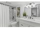 Bathroom featuring a shower over the tub, neutral-colored flooring, and modern vanity at 1964 Tanglewood Ne Dr, St Petersburg, FL 33702