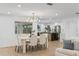 Bright dining room and open kitchen, with a contemporary chandelier, table, and chairs at 1964 Tanglewood Ne Dr, St Petersburg, FL 33702