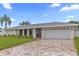 Charming home with a brick driveway, white exterior, and well-maintained landscaping at 1964 Tanglewood Ne Dr, St Petersburg, FL 33702