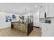 Modern kitchen with sleek black island, stainless steel appliances, and light-colored cabinets at 1964 Tanglewood Ne Dr, St Petersburg, FL 33702