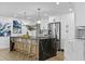 Contemporary kitchen boasts a waterfall island, counter seating, and modern appliances at 1964 Tanglewood Ne Dr, St Petersburg, FL 33702