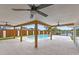 Spacious covered patio with ceiling fans overlooking a luxurious pool and waterfront access at 1964 Tanglewood Ne Dr, St Petersburg, FL 33702