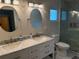 Modern bathroom showcasing double sinks, marble countertop, decorative lights, and glass walk-in shower at 2005 Capri Rd, Valrico, FL 33594