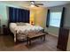 Comfortable bedroom featuring a decorative ceiling fan, wood floors, and bright natural light at 2005 Capri Rd, Valrico, FL 33594
