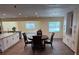 Open dining area featuring dark wood floors and an eat-in kitchen with white cabinets and granite countertops at 2005 Capri Rd, Valrico, FL 33594