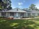 Inviting single-story home with a welcoming facade and lush green lawn, perfect for Gathering living at 2005 Capri Rd, Valrico, FL 33594