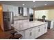 Bright kitchen with white cabinets, granite countertops, stainless steel appliances, and a functional island at 2005 Capri Rd, Valrico, FL 33594