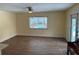 An airy living room space showcasing tiled floors, a ceiling fan, and a sliding glass door to the pool at 2005 Capri Rd, Valrico, FL 33594