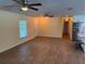 Open-concept living area with wood-look floors, ample natural light, and a seamless flow to the kitchen at 2005 Capri Rd, Valrico, FL 33594