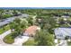 Aerial shot of a home nestled in a lush, green neighborhood, featuring mature trees and well-kept lawns at 20352 Astoria Ave, Port Charlotte, FL 33952