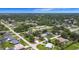 Expansive aerial view showcasing a lush residential neighborhood with tree-lined streets and varied home styles at 20352 Astoria Ave, Port Charlotte, FL 33952