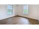 Bedroom with wood-look flooring with a view of pool from the window at 20352 Astoria Ave, Port Charlotte, FL 33952