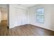 Bedroom with wood-look flooring and view of screened in lanai at 20352 Astoria Ave, Port Charlotte, FL 33952