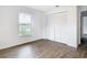 Bedroom with wood-look floors, closet, and exterior view at 20352 Astoria Ave, Port Charlotte, FL 33952