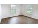 Bedroom features wood-look flooring and a view of the yard at 20352 Astoria Ave, Port Charlotte, FL 33952