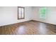 Bright bedroom with wooden floors and two windows at 20352 Astoria Ave, Port Charlotte, FL 33952