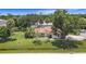 Charming single-story home with a well-manicured lawn, mature trees, and a welcoming entrance at 20352 Astoria Ave, Port Charlotte, FL 33952