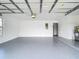 Spacious two-car garage with painted floors, and access to interior of home at 20352 Astoria Ave, Port Charlotte, FL 33952