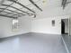 Clean two-car garage with painted floor, modern garage door, and access door at 20352 Astoria Ave, Port Charlotte, FL 33952