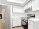 Updated kitchen featuring stainless steel appliances, white cabinets, modern fixtures, and a bright atmosphere at 20352 Astoria Ave, Port Charlotte, FL 33952