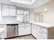 Bright kitchen with stainless steel appliances, quartz countertops, and a large garden window at 20352 Astoria Ave, Port Charlotte, FL 33952