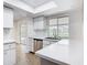 Sunlit kitchen featuring quartz countertops, stainless steel appliances, and a view to the backyard at 20352 Astoria Ave, Port Charlotte, FL 33952