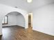 Bright living space with wood-look floors, white walls, archway, and a window providing natural light at 20352 Astoria Ave, Port Charlotte, FL 33952