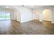 Spacious living area featuring wood-look floors, access to the pool, and an open floor plan at 20352 Astoria Ave, Port Charlotte, FL 33952