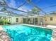 Backyard pool, screened in, with brick paver decking, and exterior access to home at 20352 Astoria Ave, Port Charlotte, FL 33952