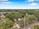 Areal view showcases the home nestled among lush green trees, surrounded by a tranquil neighborhood at 205 W Wheeler Rd, Seffner, FL 33584