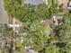 Aerial view showcases the home nestled among lush green trees, surrounded by a tranquil neighborhood at 205 W Wheeler Rd, Seffner, FL 33584