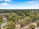 Areal view showcases the home nestled among lush green trees, surrounded by a tranquil neighborhood at 205 W Wheeler Rd, Seffner, FL 33584
