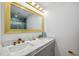 Elegant bathroom featuring a marble countertop, dual sinks, and a gold trimmed shower at 205 W Wheeler Rd, Seffner, FL 33584