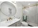 Renovated bathroom features gold accents and a seamless glass shower with modern finishes at 205 W Wheeler Rd, Seffner, FL 33584