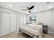 Bright bedroom with a comfortable queen-sized bed, closet, and bedside tables and stylish floors and ceiling fan at 205 W Wheeler Rd, Seffner, FL 33584