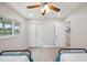 Bright bedroom with a ceiling fan, closet, and light gray vinyl flooring at 205 W Wheeler Rd, Seffner, FL 33584