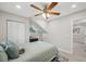 Bright bedroom has a window, closet, and soft neutral wall and bedding colors at 205 W Wheeler Rd, Seffner, FL 33584