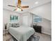 Bright bedroom includes a window, closet, and a side table with a plant at 205 W Wheeler Rd, Seffner, FL 33584