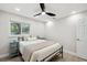 Bright bedroom with a comfortable queen-sized bed, bedside tables and stylish floors, trim, and a modern ceiling fan at 205 W Wheeler Rd, Seffner, FL 33584
