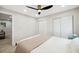 Bright bedroom with a queen-sized bed, bedside tables, stylish floors, modern ceiling fan, and dual closets at 205 W Wheeler Rd, Seffner, FL 33584