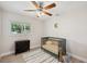 Cozy Bedroom featuring a crib, dresser, area rug, and natural lighting at 205 W Wheeler Rd, Seffner, FL 33584