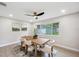 Bright dining room features modern light fixtures, light wood floors, and an outdoor view at 205 W Wheeler Rd, Seffner, FL 33584