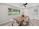 Bright dining room shows large windows and a neutral color palette with view of fenced yard at 205 W Wheeler Rd, Seffner, FL 33584