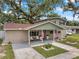 Charming home exterior with front porch, manicured landscaping, and inviting curb appeal at 205 W Wheeler Rd, Seffner, FL 33584