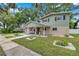 Charming two-story home with a well-maintained lawn and inviting front porch at 205 W Wheeler Rd, Seffner, FL 33584