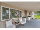Inviting front porch with comfortable seating, potted plants, and a view of the landscaped front yard at 205 W Wheeler Rd, Seffner, FL 33584