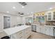 Modern kitchen with island and stainless steel appliances, bright cabinets and modern backsplash at 205 W Wheeler Rd, Seffner, FL 33584