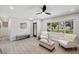 Bright living room with light wood floors, neutral decor, and a ceiling fan at 205 W Wheeler Rd, Seffner, FL 33584