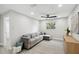 Bright living room featuring a comfortable couch, stylish floors, and modern ceiling fan and lights at 205 W Wheeler Rd, Seffner, FL 33584
